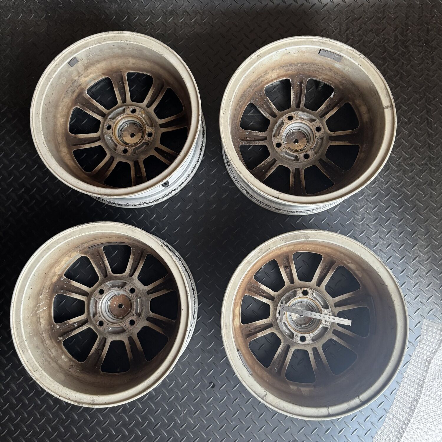 Four DCN Daihatsu genuine option wheels photographed from the rear