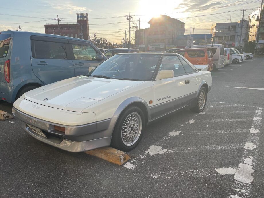 White Toyota MR2 (AW11) Supercharger parked, fitted with aftermarket mesh wheels