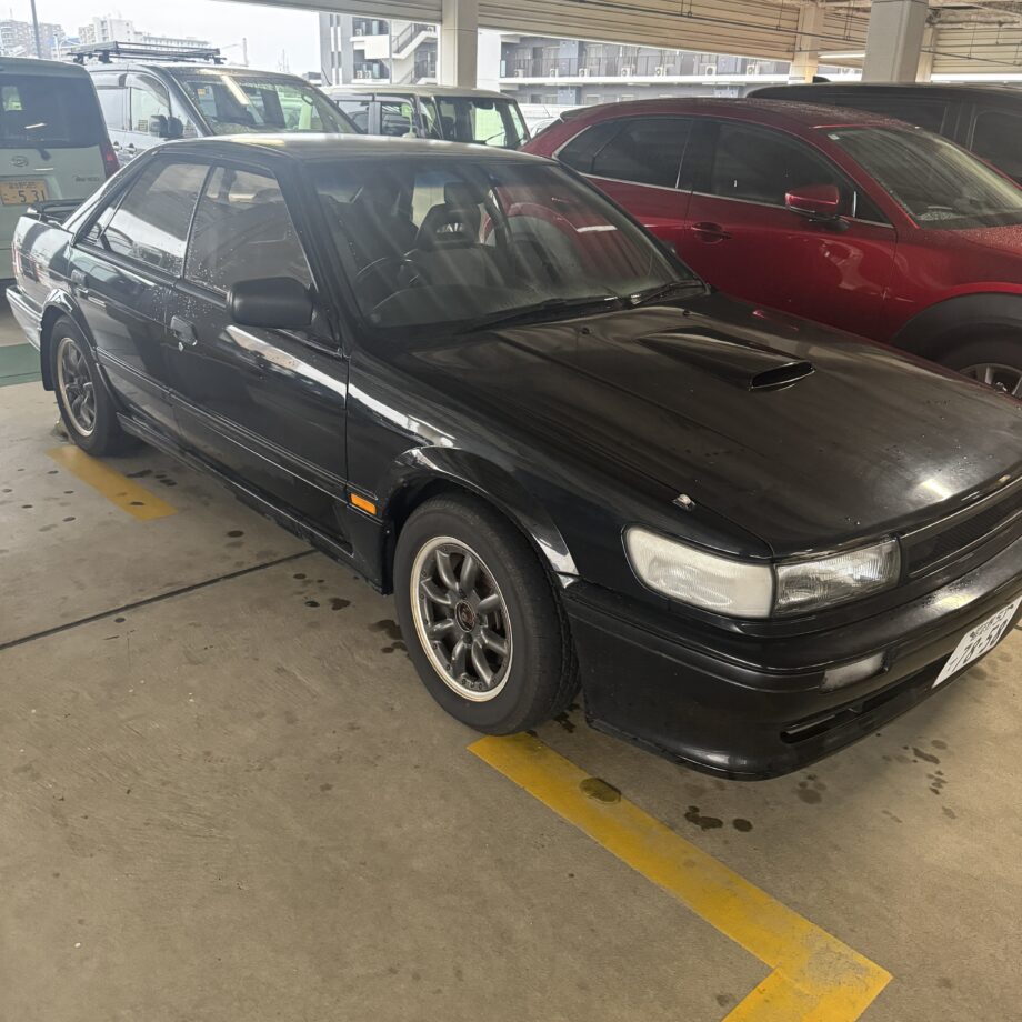 Black Nissan Bluebird (U12) with aftermarket RS Watanabe 8-spoke wheels, street snap