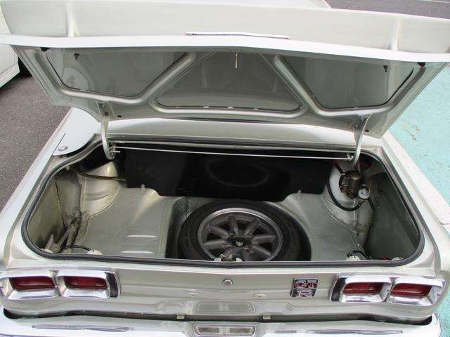 Trunk and spare wheel of a Hakosuka-era Skyline GT finished in GT-R spec, GT-R badging visible on the lid
